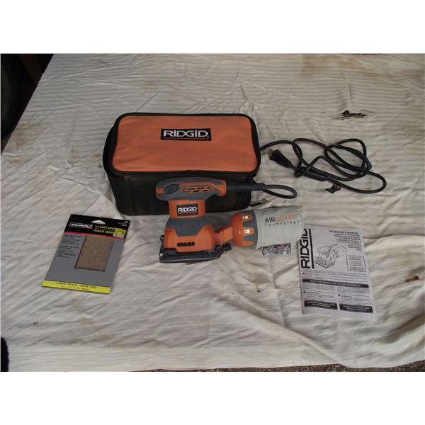 Rigid Palm Sander. Has dust collection and carry case. Complete with 4 sanding pads.