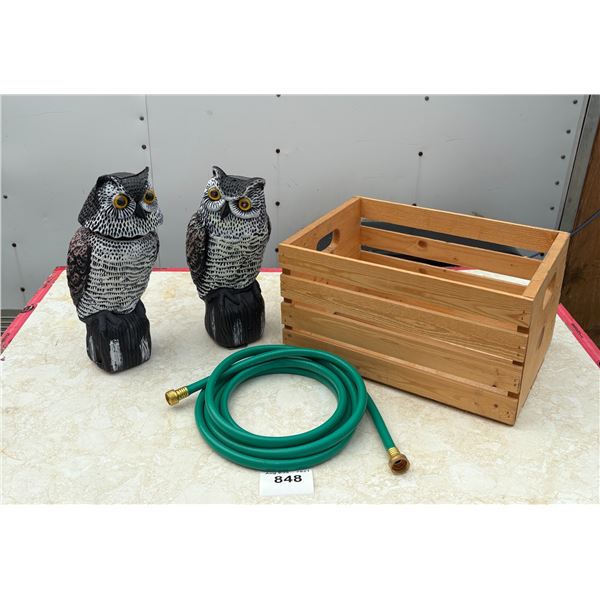wooden box with owls and garden hose