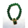 Image 1 : 28)  GREEN JADE COLORED BRACELET WITH GOLD