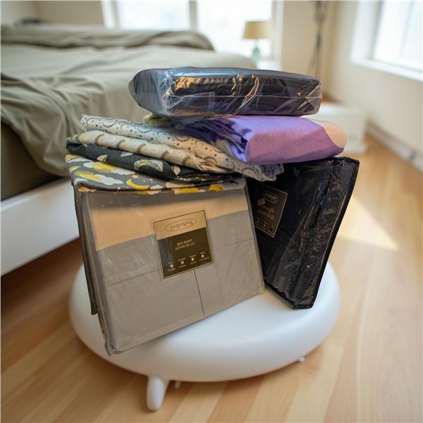 Group of new assorted bed sheets, bed skirts etc.