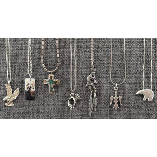 SEVEN STERLING SILVER NECKLACES WITH PENDANTS.