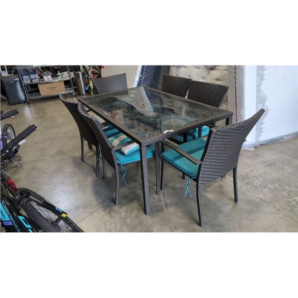 GLASS AND RATTAN PATIO TABLE AND 6 CHAIRS