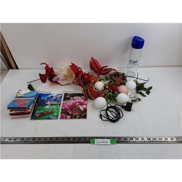 InTouch 2025 Magazines, 10″ EDP Water Bottle, Apple Lightning Charger, Plastic Flower Decor