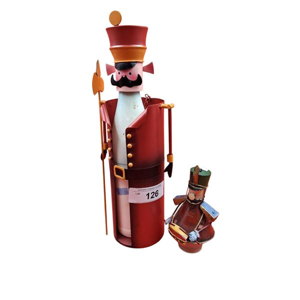 Large metal nutcracker bottle and small figure