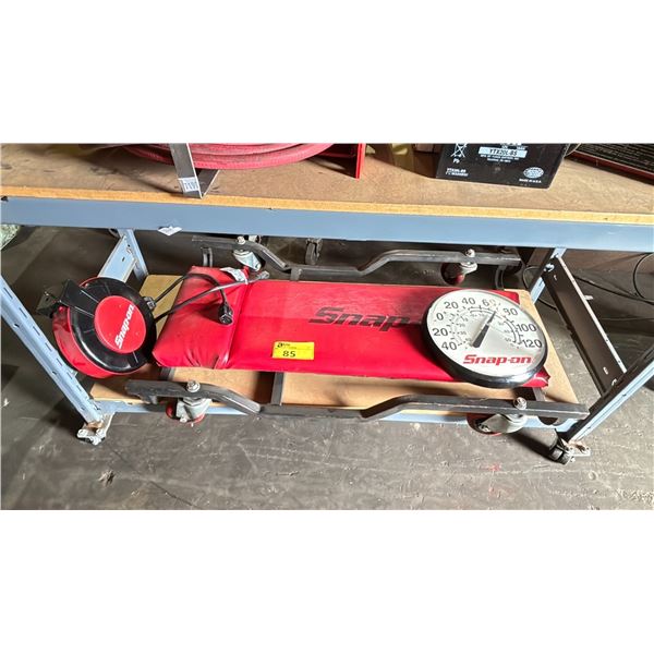 SHELF OF ASSORTED SNAP-ON TOOLS INCLUDING; MECHANICS CREEPER, VINTAGE SNAP-ON THERMOMETER