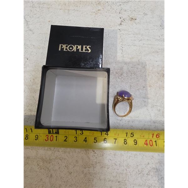 Gold colored ring with blue stone