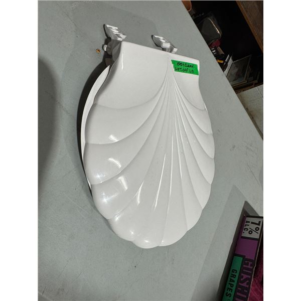 Toilet seat with sculpted lid bolts are taped under lid