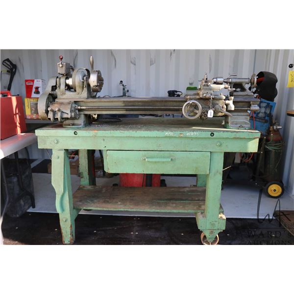 South Bend model A precision, screw cutting metal lathe w/ stand and accessories. Includes tail stoc