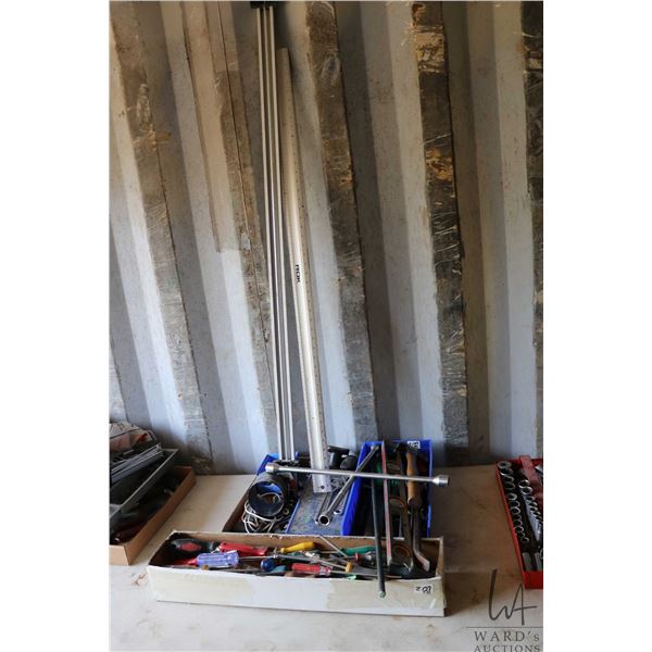 Assortment of hand tools including screwdrivers, pry bars, levels, wrenches, etc