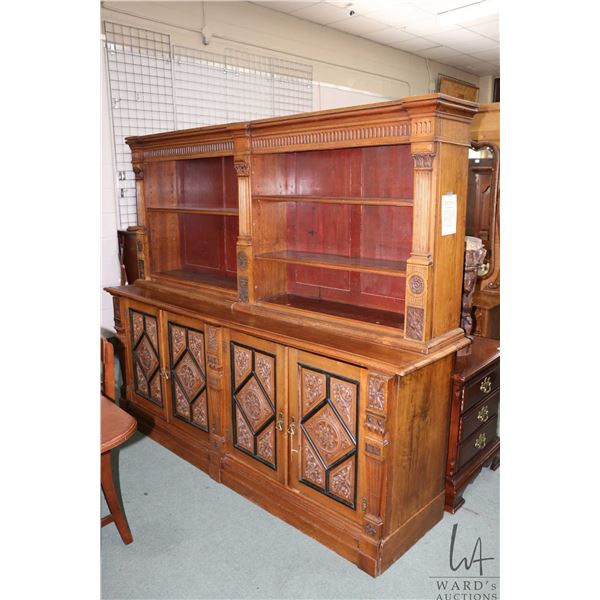 Antique hand carved walnut sideboard with book storage/ display shelves, each door in base features 
