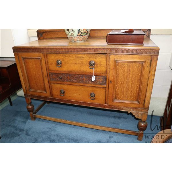 Antique quarter cut oak sideboard with carved decoration and appears to be original pulls, 43" to to
