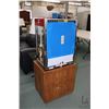 Image 1 : Cretors popcorn machine 27" H X 20" W X 14" D, in unused condition, sitting on 23" H shop made two d