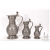 Image 1 : Three antique graduated pewter lidded ewers, 5" to 10"