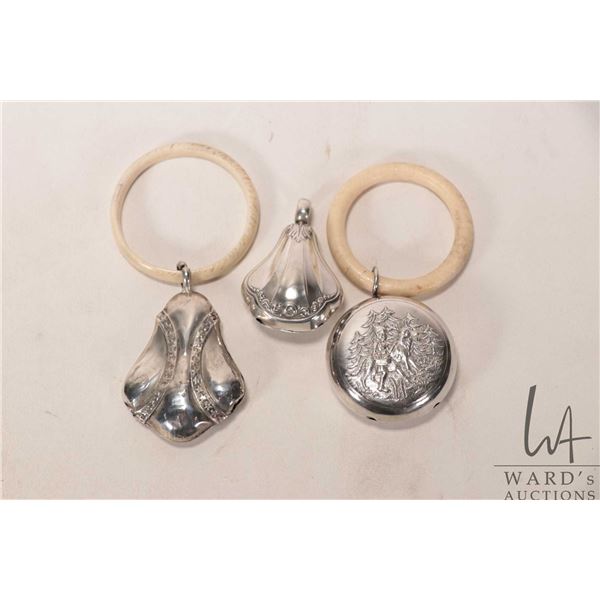 Three vintage silver plate baby rattles including Little Red Riding Hood with the wolf, and two Deco