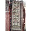 Image 1 : Fringed carpet runner with multiple medallions, floral design and highlights of black, cream, mauve 