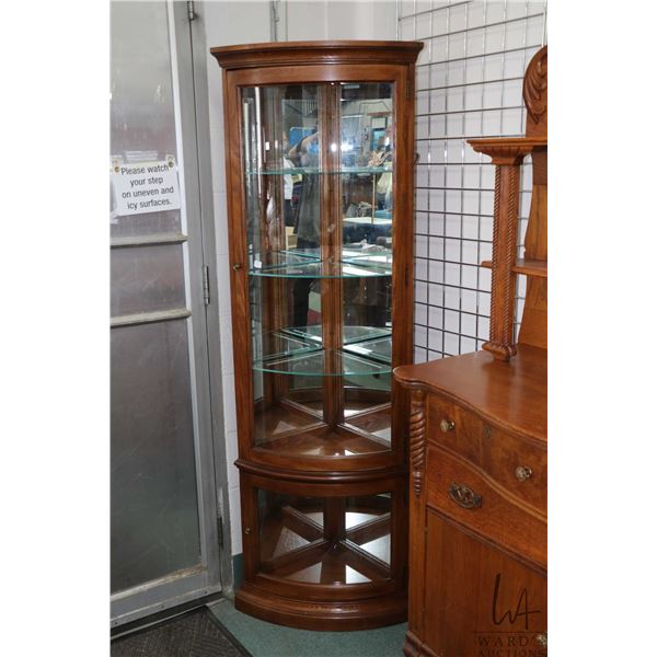Semi contemporary oak and curved glass, illuminated two door corner cabinet with adjustable glass sh