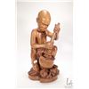 Image 1 : Hand carved African wooden figure of a woman with a pot on an open fire, 18" in height, label on und