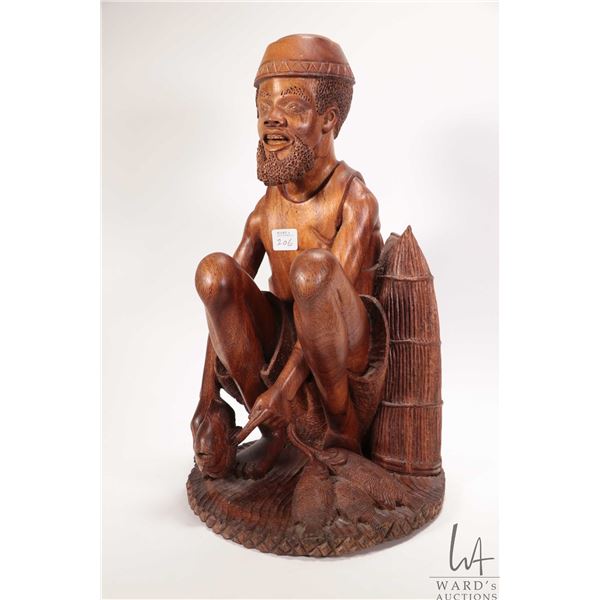 Hand carved wooden sculpture of a fisherman, 16" in height. Note: Not available for shipping. Local 