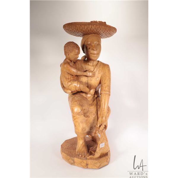 Hand made African wooden carving of a woman and child, no signature seen, 25" in height. Note: Not a