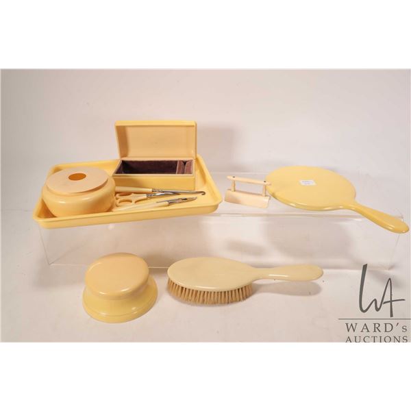 Selection of French ivory dresser pieces including powder box, hair receiver, nail tools, jewel case