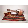 Image 1 : Vintage flat-back mandolin, a small pair of bongo drums, maracas and a woven colourful throw