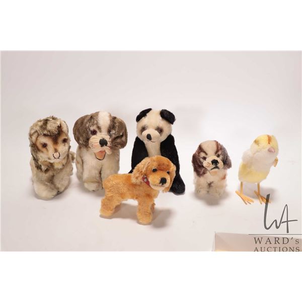 Six vintage Steiff animals including dogs, lion, panda bear and chicken
