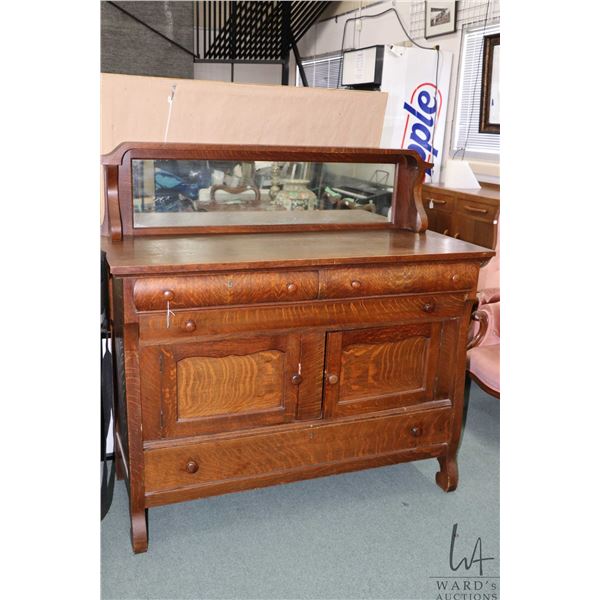 Antique quarter cut oak Empire style sideboard with three doors and three drawers plus mirrored back