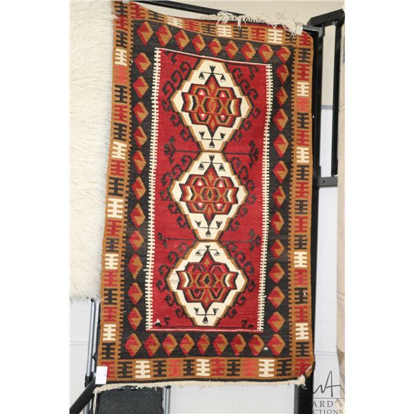Woven geometric carpet with triple medallion and highlights of brown, black and cream etc. 41" X 76"
