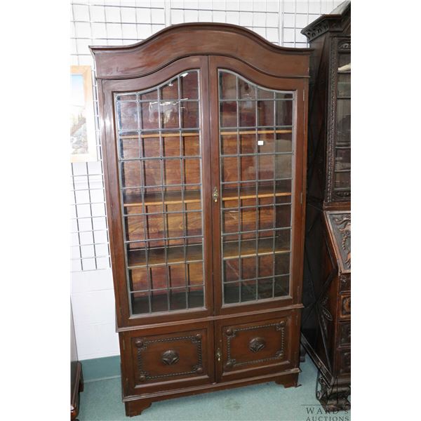Antique domed top book cabinet with raised panel doors below and two glazed leaded panel doors 76" H