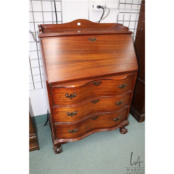 Antique mahogany fall front secretaire with three serpentine drawers, carved ball and claw feet and 