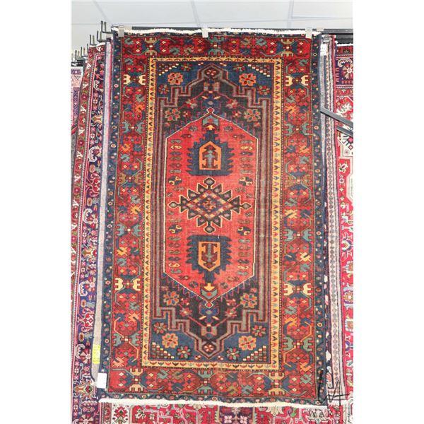 100% hand made Iranian carpet "Lori" with center medallion, red background and highlights of blues, 