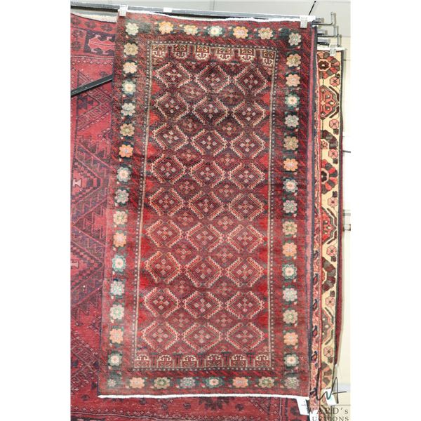 100% hand made Iranian carpet "Baluchi" with overall geometric design, red background and highlights