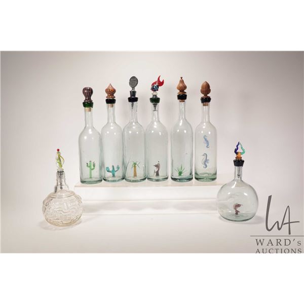 Eight decorative glass bottles, six of which have attached internal accent and each have decorative 