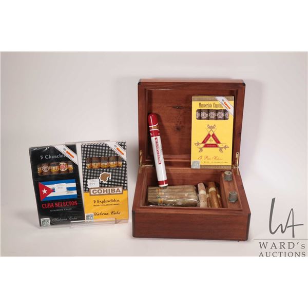 Modern cigar humidor and selection of cigars including Cohiba, Monte Cristo, etc