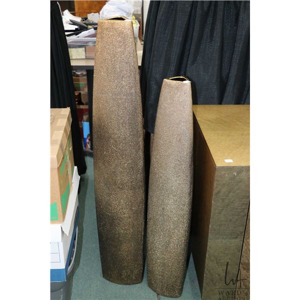Two burnished gold modern floor vase including 39" and 47" in heights. Note: Not available for shipp
