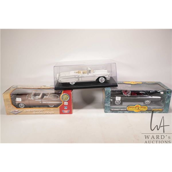 Three 1:18 scale die cast cars including 1960 Impala, a 1964 Impala and a 1958 Impala