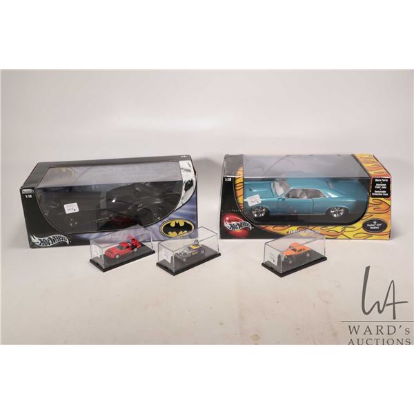 Five die cast Hot wheels cars including three 1:64 scale cars, 1:18 scale '66 Pontiac GTO and 1:18 s