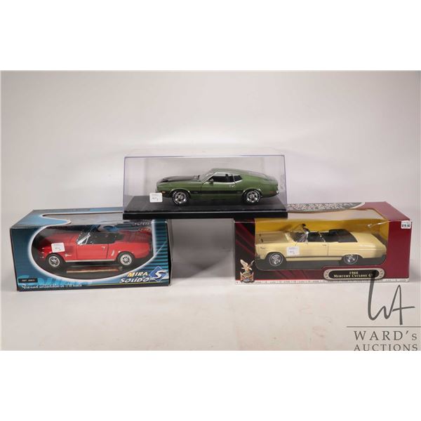 Three 1:18 scale die cast models including '72 Mustang Mach I, 1966 Mercury Cyclone GT and a 1965 Mu