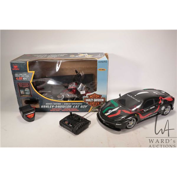 Two remote control vehicles including Ferrari race car and a Harley Davidson fat boy motorcycle, bot