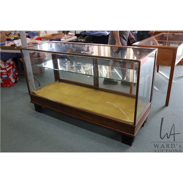 Antique wood and glass counter style display case with sliding glass doors and one shelf, 36" H X 60