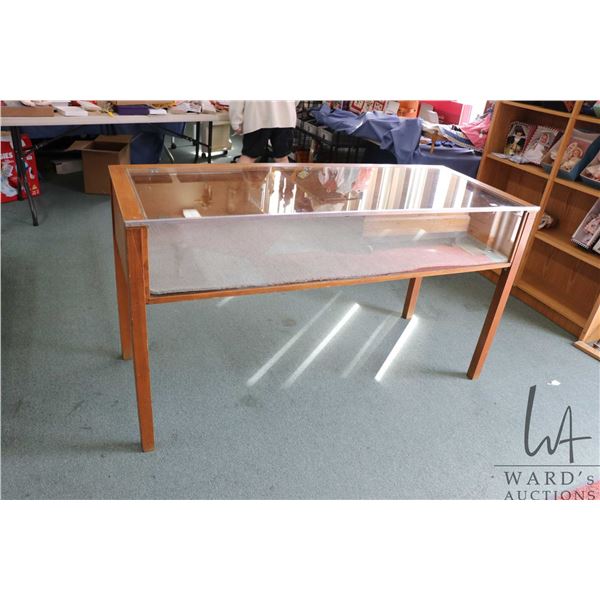 Counter height shallow glass display case with drop down back, 33" H X 60" W X 24"