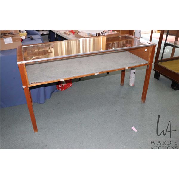 Counter height shallow glass display case with drop down back, 33" H X 60" W X 24" Note: Damaged top