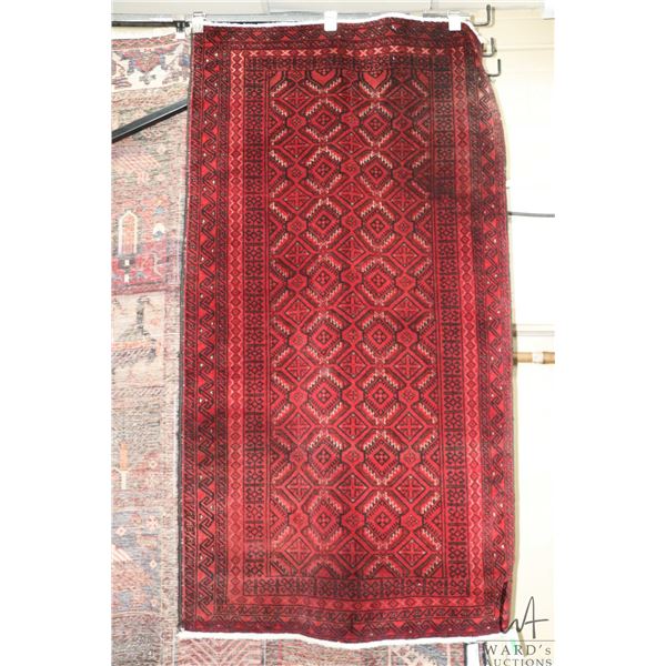 100% hand made Iranian wool scatter carpet "Baluchi" with red background and highlights of black and