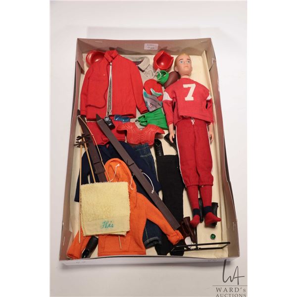 Vintage Barbie Ken doll with a selection of accessories and outfits including skis, football outfit 