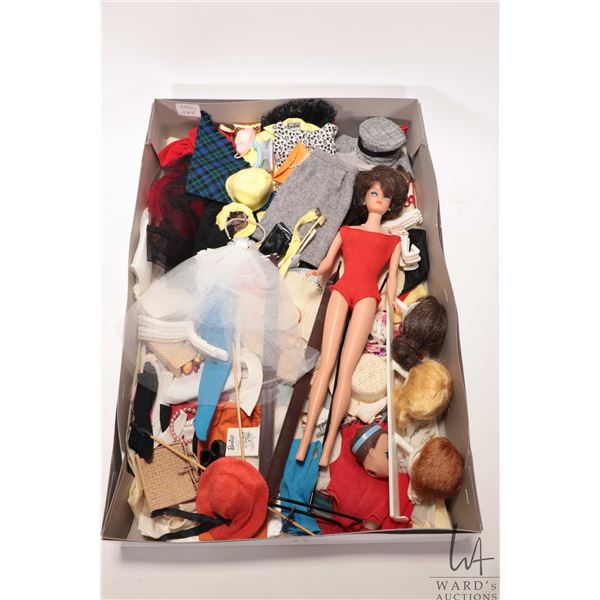 Vintage Bubble Cut Barbie doll with original stand and a large number of fashions and accessories pl