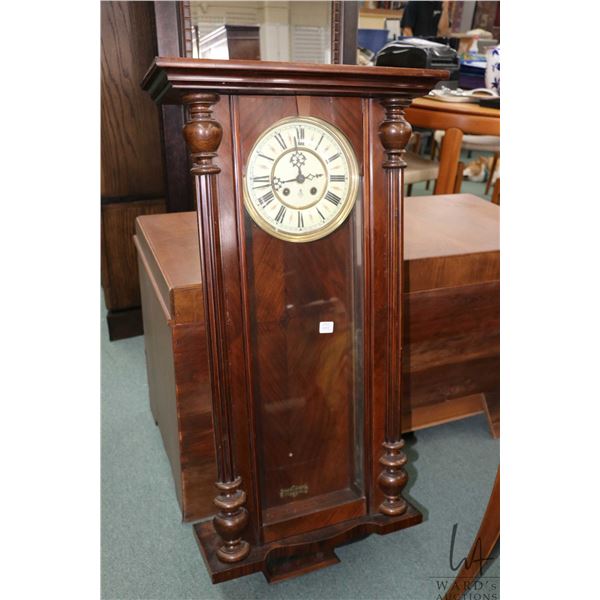 Antique wall clock w/ chiming movement. Note: Missing pendulum. Not working at time of cataloging . 