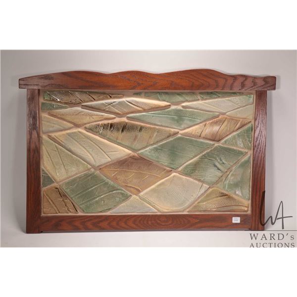 Oak framed tilework featuring grid work pattern seeming to depict prairie field from an aerial view,