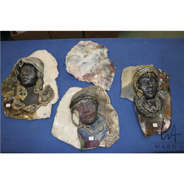 Four hand made clay mask, initalled by artist JD, each approximately 16" X 12". Note: Not available 
