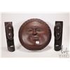 Image 1 : Three hand made wooden African carvings including set of book ends with carved faces and a round sun