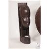 Image 2 : Three hand made wooden African carvings including set of book ends with carved faces and a round sun